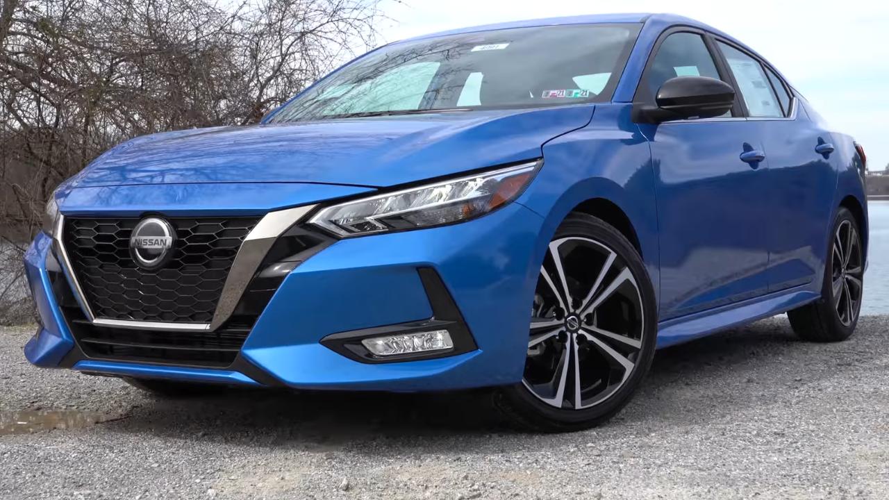 A Blue Nissan Sentra parked on the road and sitting on an angle.